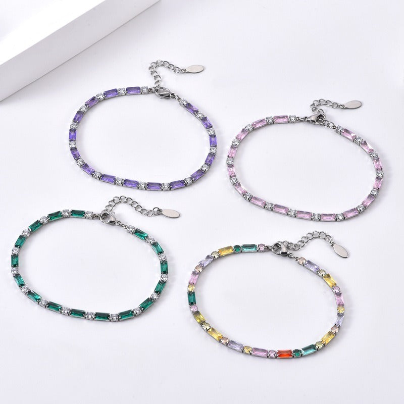 Four silver tone sparkle bracelets: purple, pink, green and mixed colors