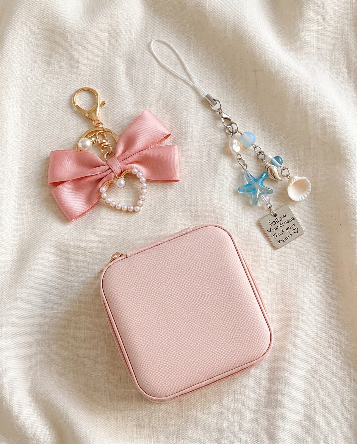 Free accessories on ivory linen: a travel jewelry case, a bow bag charm and a beaded phone chain