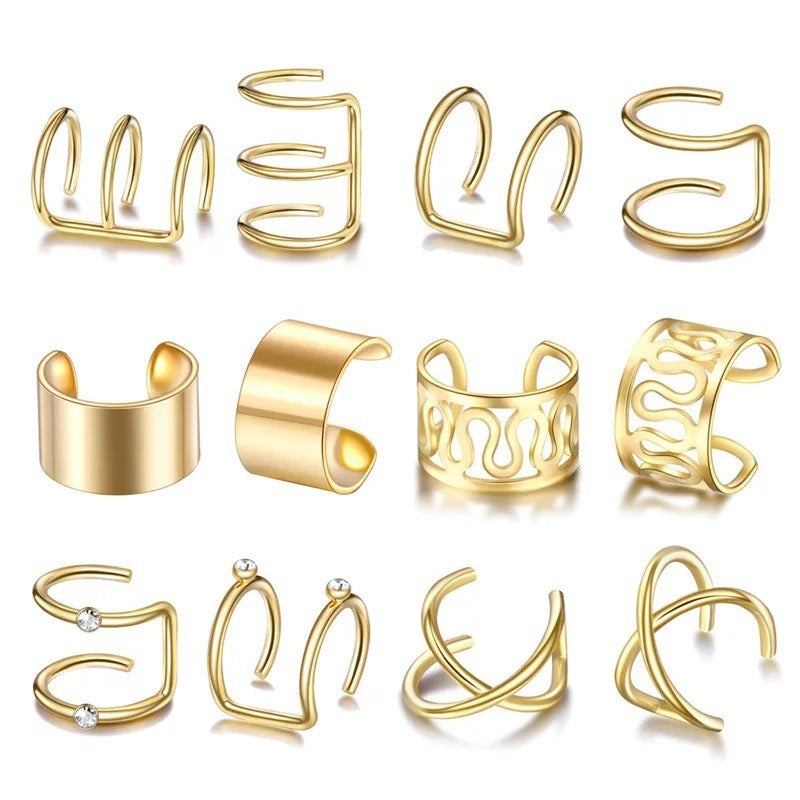 Twelve gold tone ear cuffs laid out in rows