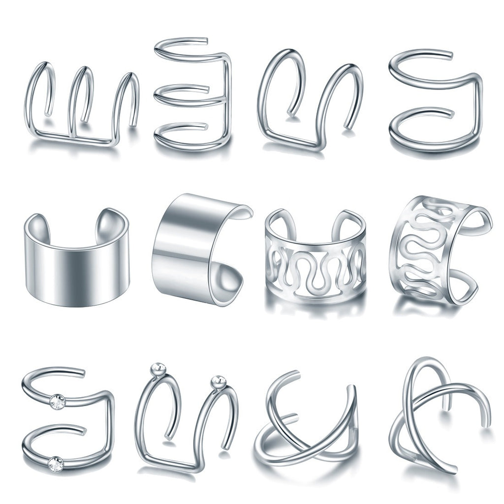 Twelve silver tone ear cuffs laid out in rows