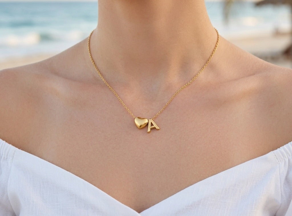 Initial necklace worn at the collarbone, a heart and the letter A
