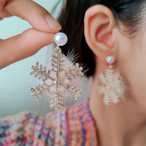 Snowflake earrings with clear stones under a faux pearl stud