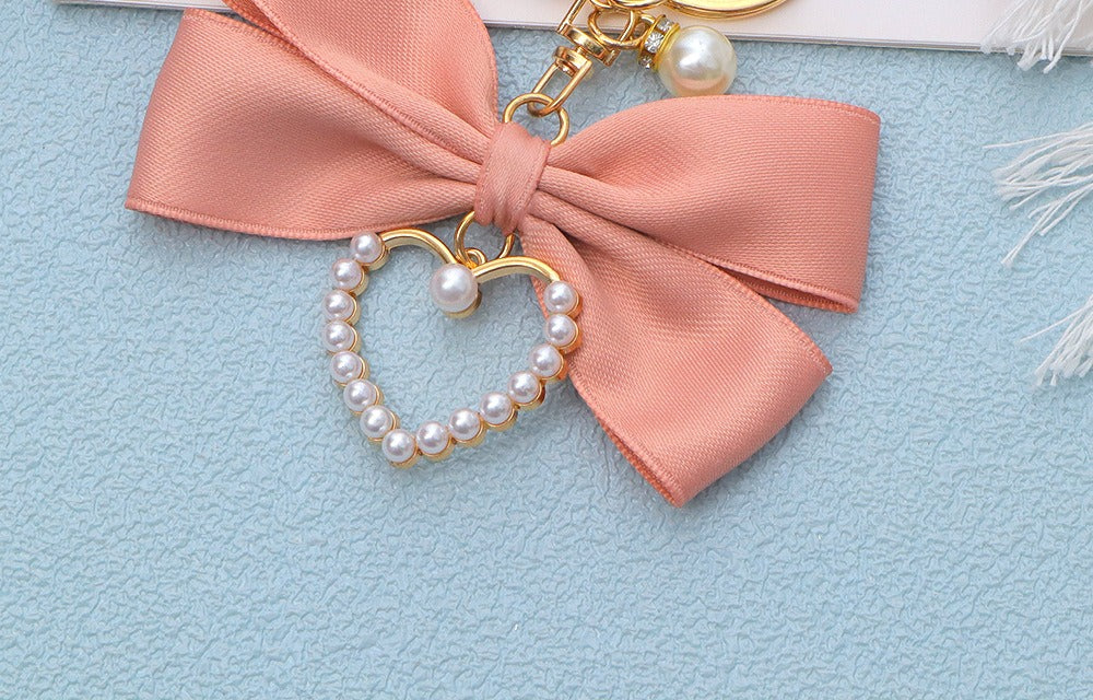 Pink bow bag charm, close up