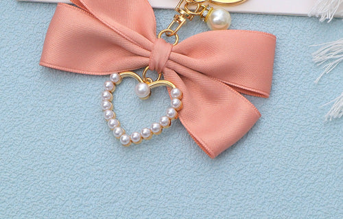Pink bow bag charm, close up