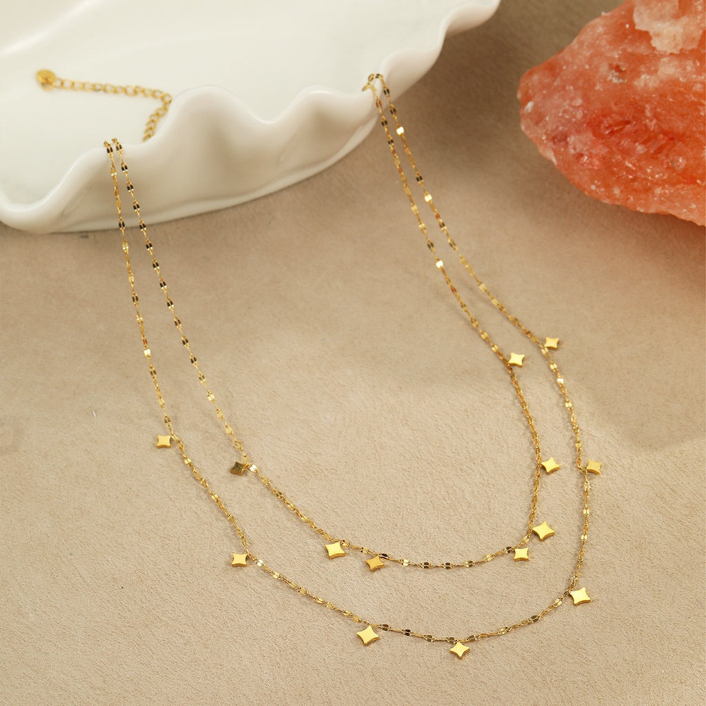 Two layered gold tone chains with small star charms