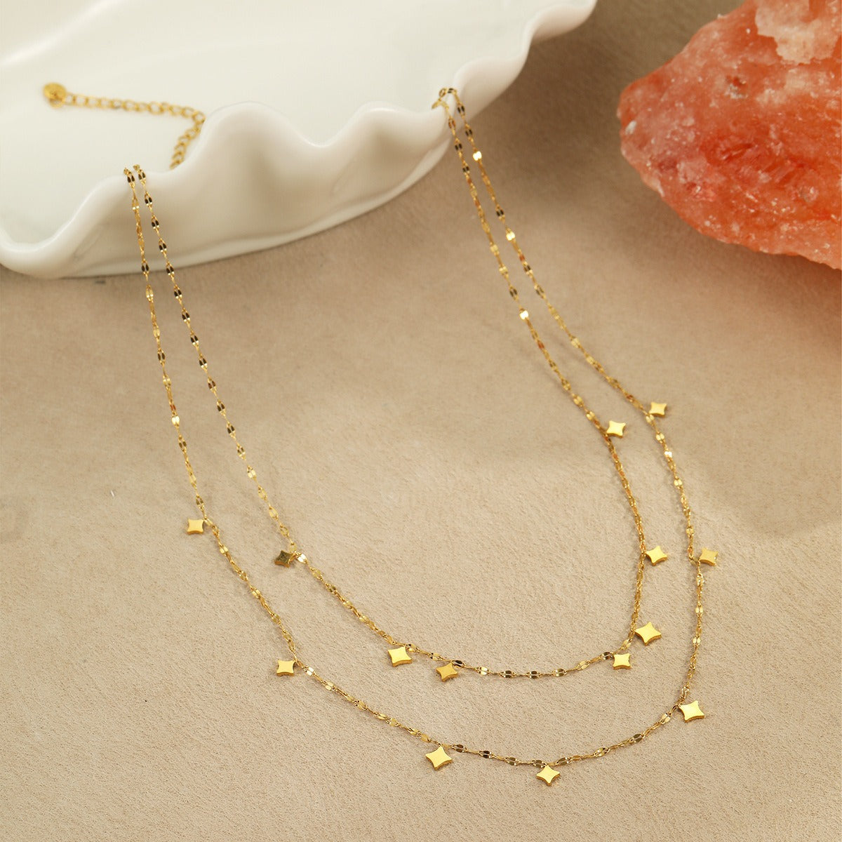 Two layered gold tone chains with small star charms