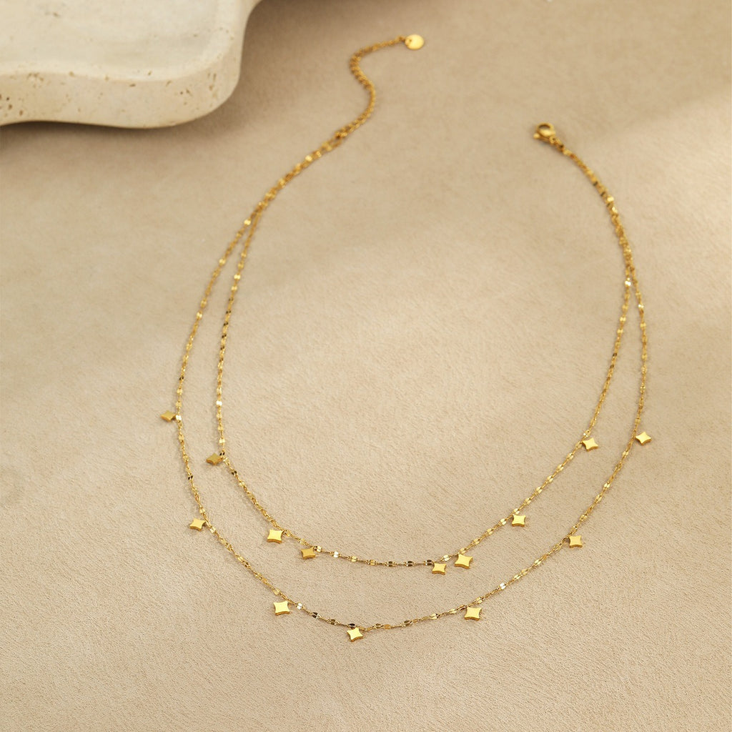 Layered gold tone necklace laid flat
