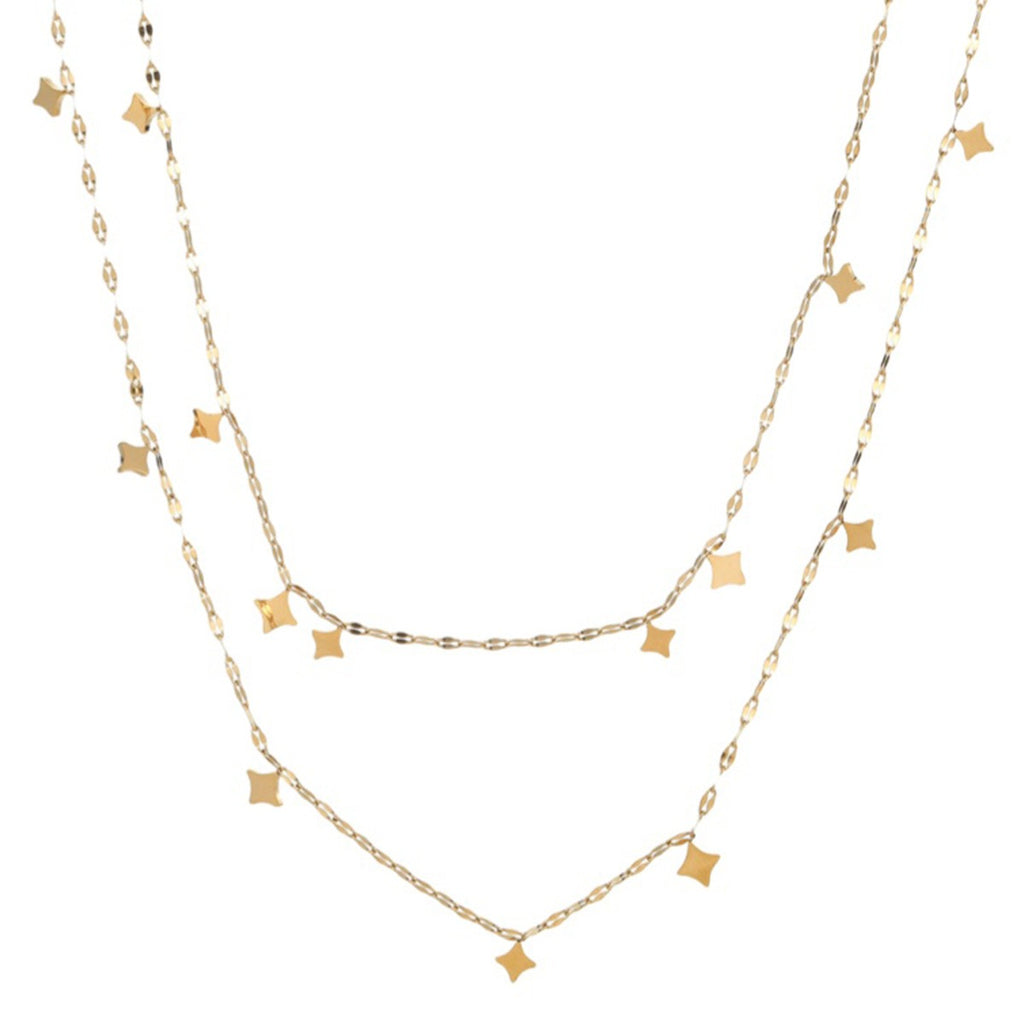 Layered gold tone necklace on white