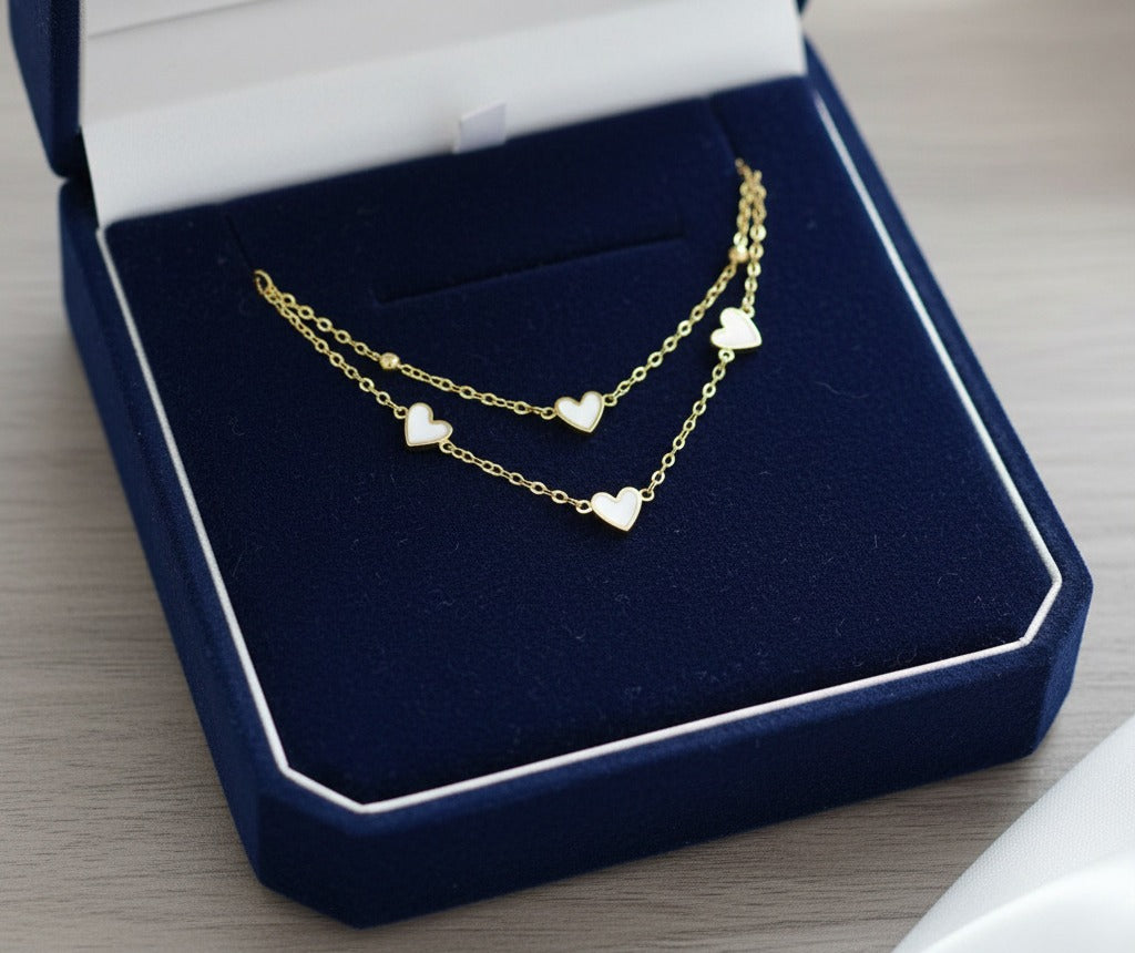 Gold tone two strand heart bracelet in a box