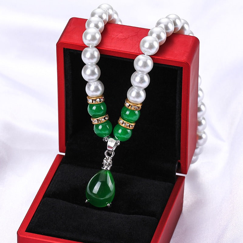 Pearl style bead necklace with green beads and a green teardrop pendant