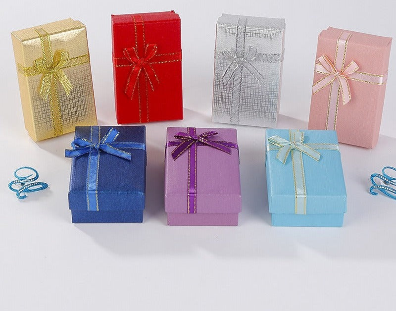 A row of small gift boxes with ribbon bows