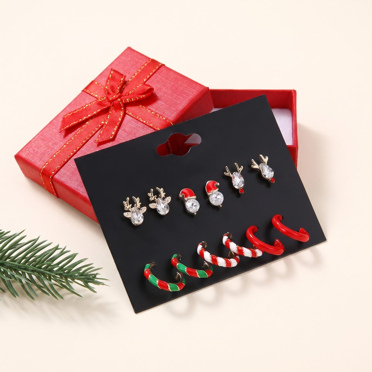 The Christmas earring card with a red gift box and a pine sprig