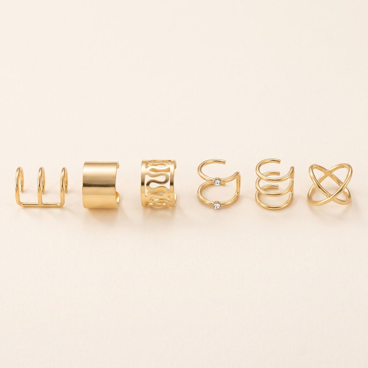 Six of the ear cuff shapes in a row, in the order they stack up the ear