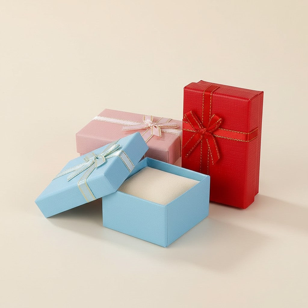 One gift box with a ribbon bow, shown in red; the color varies, chosen at packing