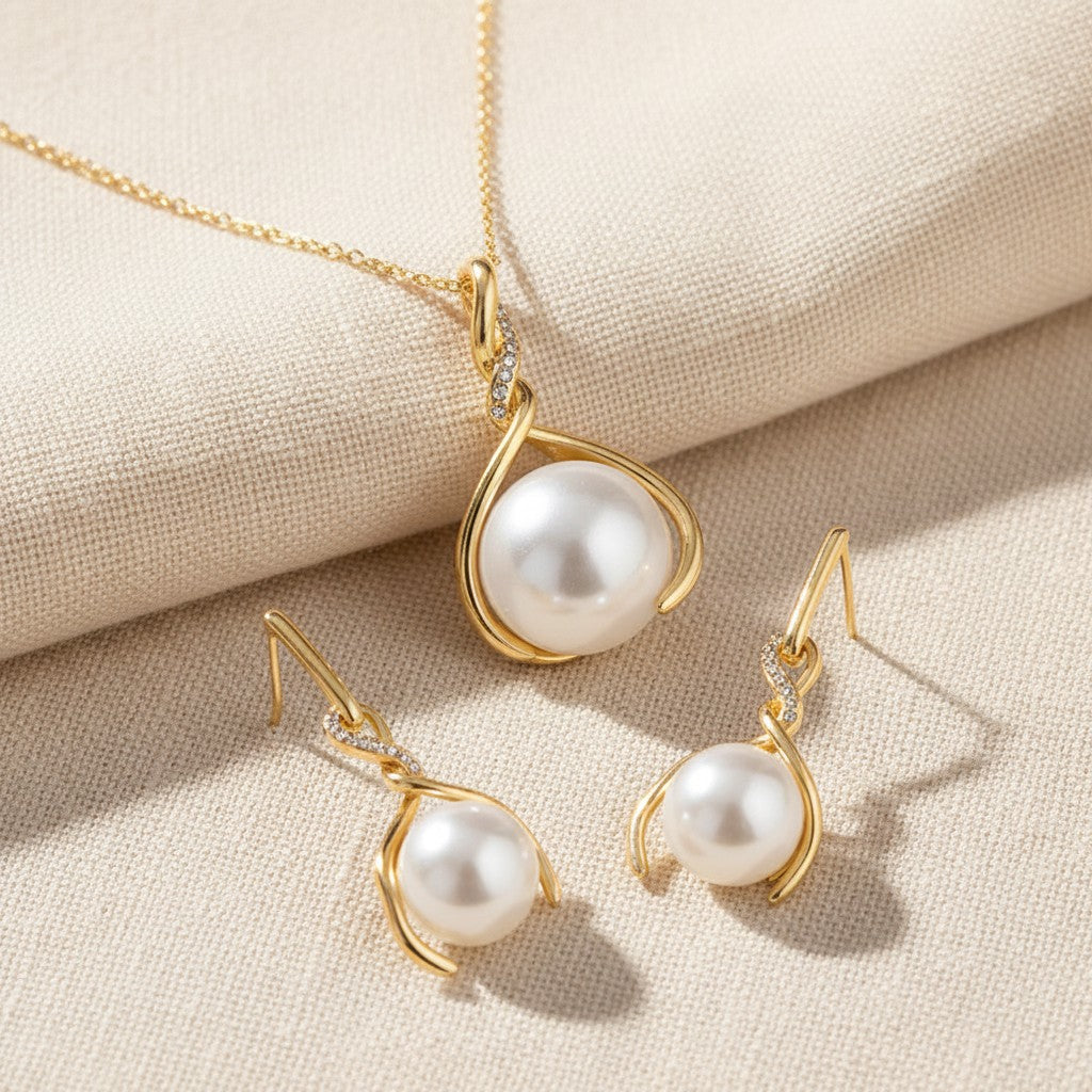 Close up of the pendant and the pair of drop earrings, each a twist holding a faux pearl