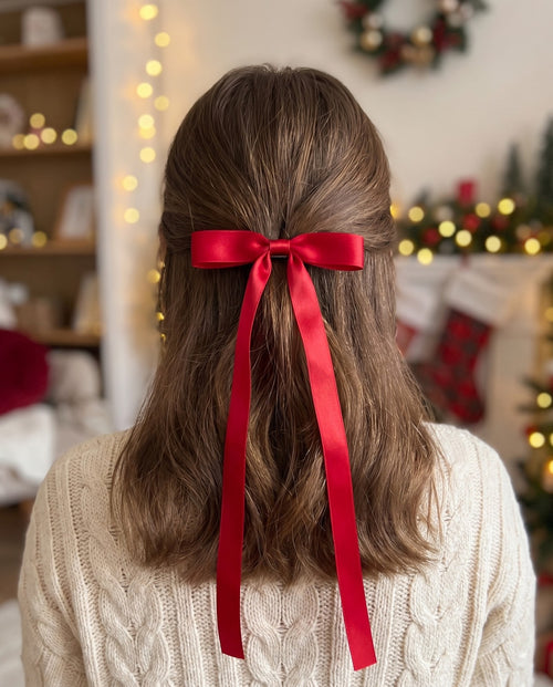 The red ribbon bow clip worn in the hair