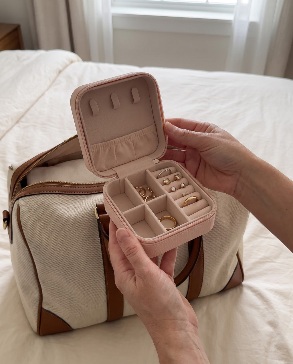 The pink travel jewelry case held in a hand